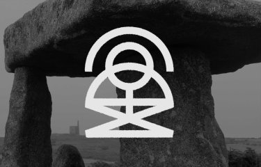 A black and white image of stacked rocks in the background with a white logo type in the foreground