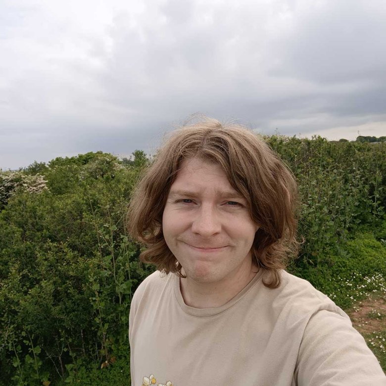 A selfie of comedy writing graduate Sean Phelan taken in a field