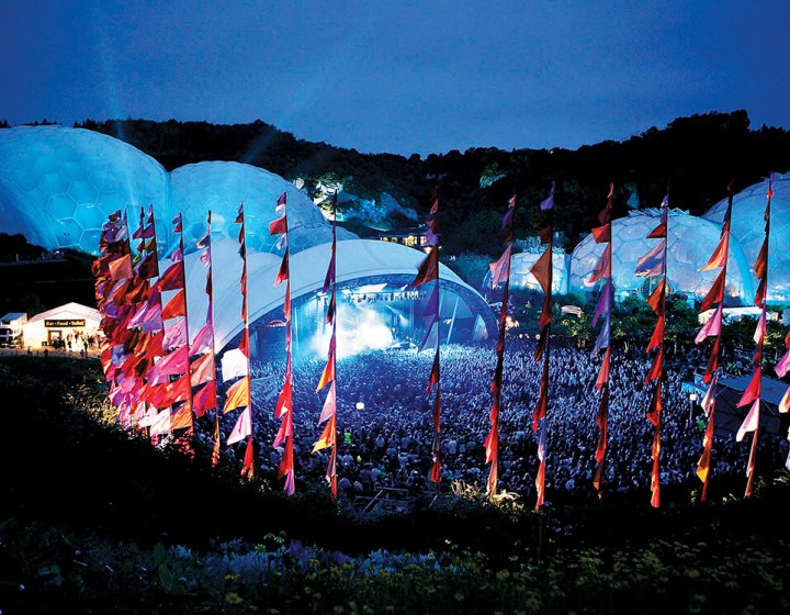 Music festival at the Eden Project with domes and pink flags