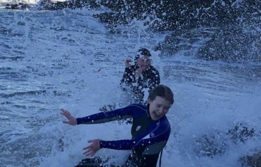 Two friends splash around in white water 