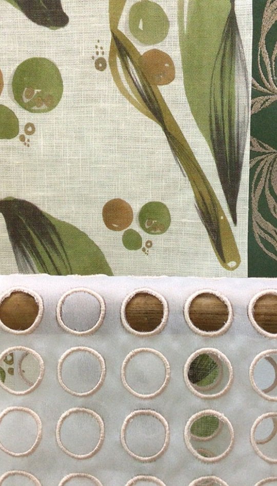 Sample of textiles in greens and creams