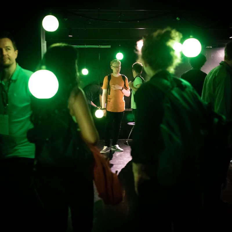 A group of people in green light
