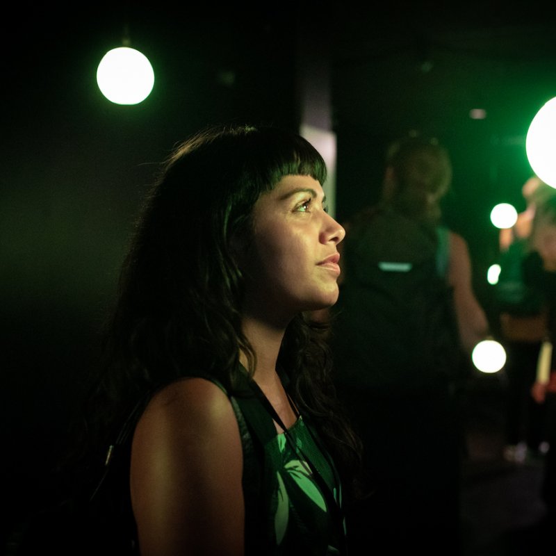 A girl with black hair in green light