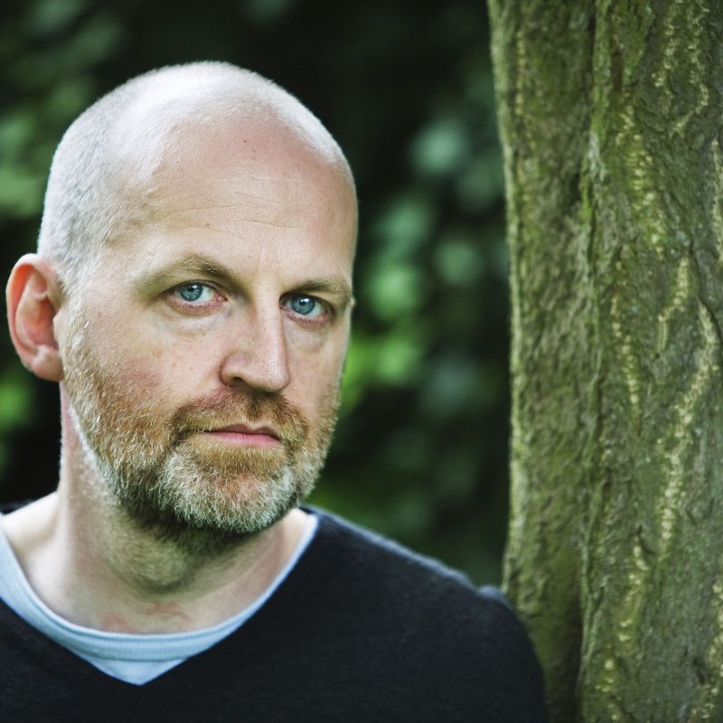 Portrait of Don Paterson OBE, English & Writing guest speaker stood next to tree.