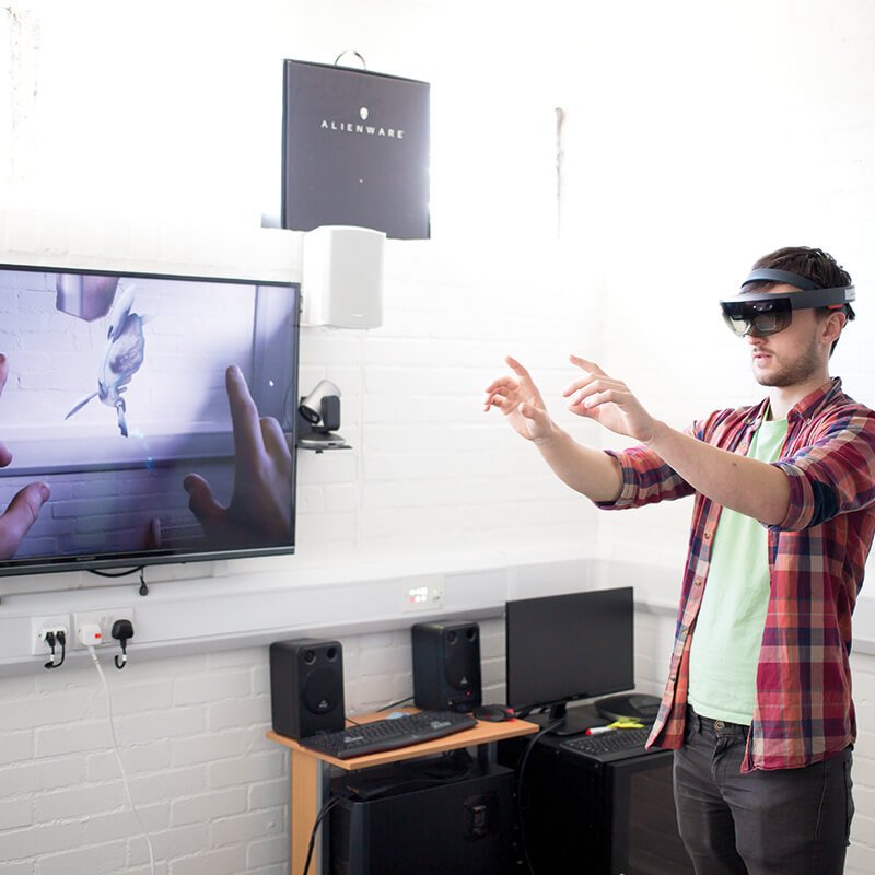 Games Academy student wearing a virtual reality headset with a TV screen