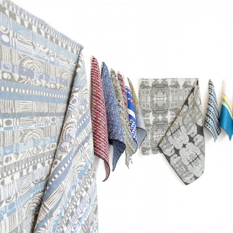 A display of different coloured jacquard woven fabrics.