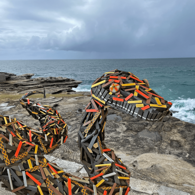A sculpture of a python by the coast