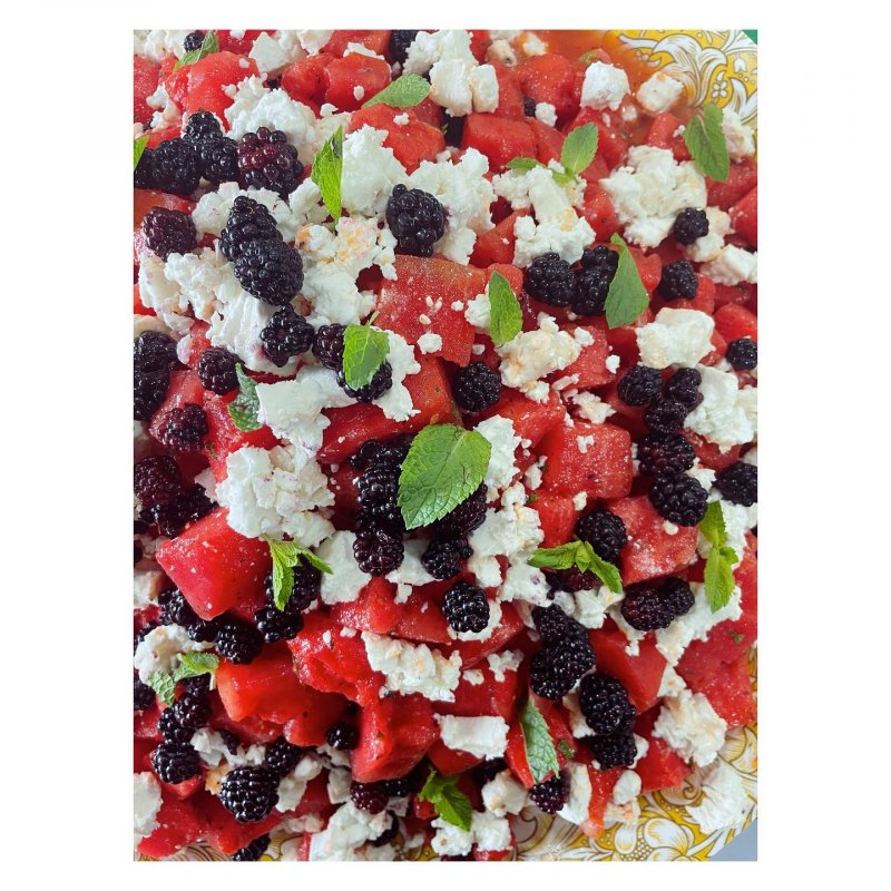 Close up of a blackberry, watermelon, feta and basil salad