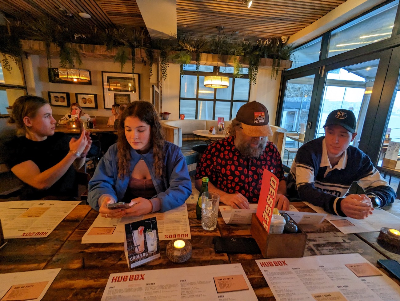 Falmouth University business students sat at a table in Hub Box restaurant