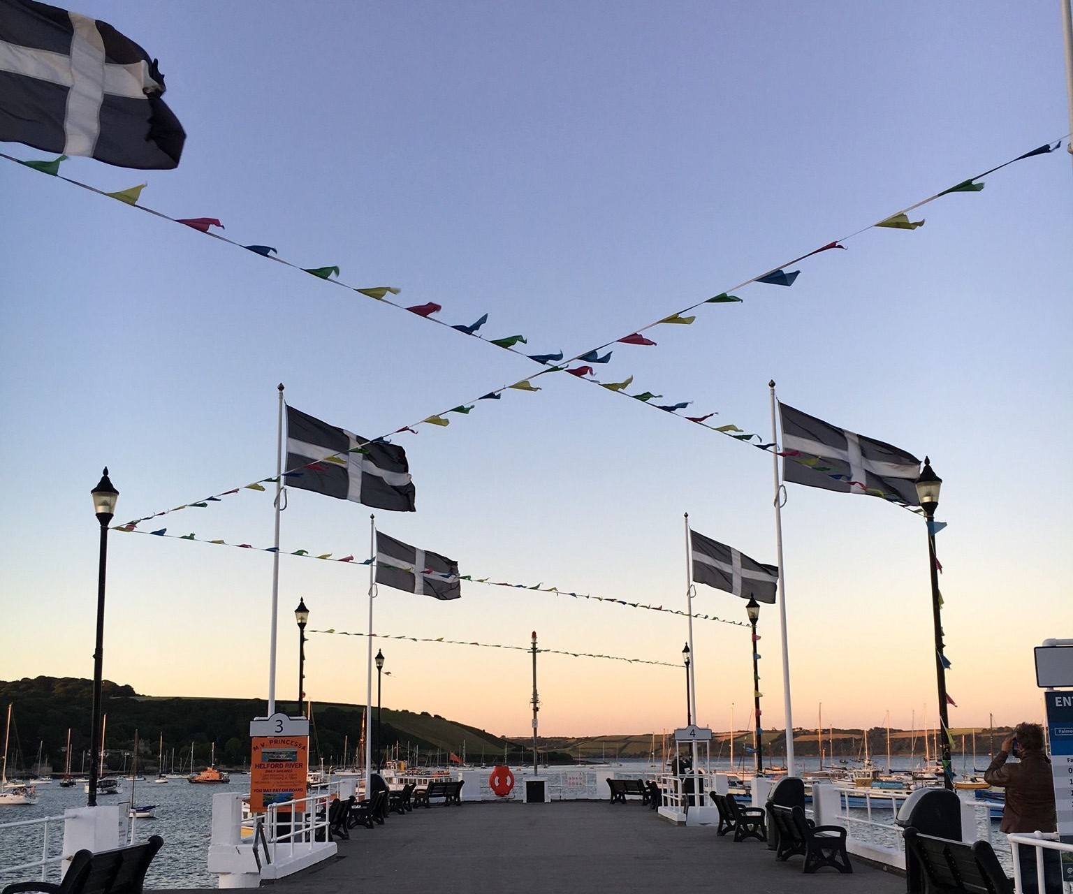 View out over a pier in Falmouth with Cornish flag in the top left corner