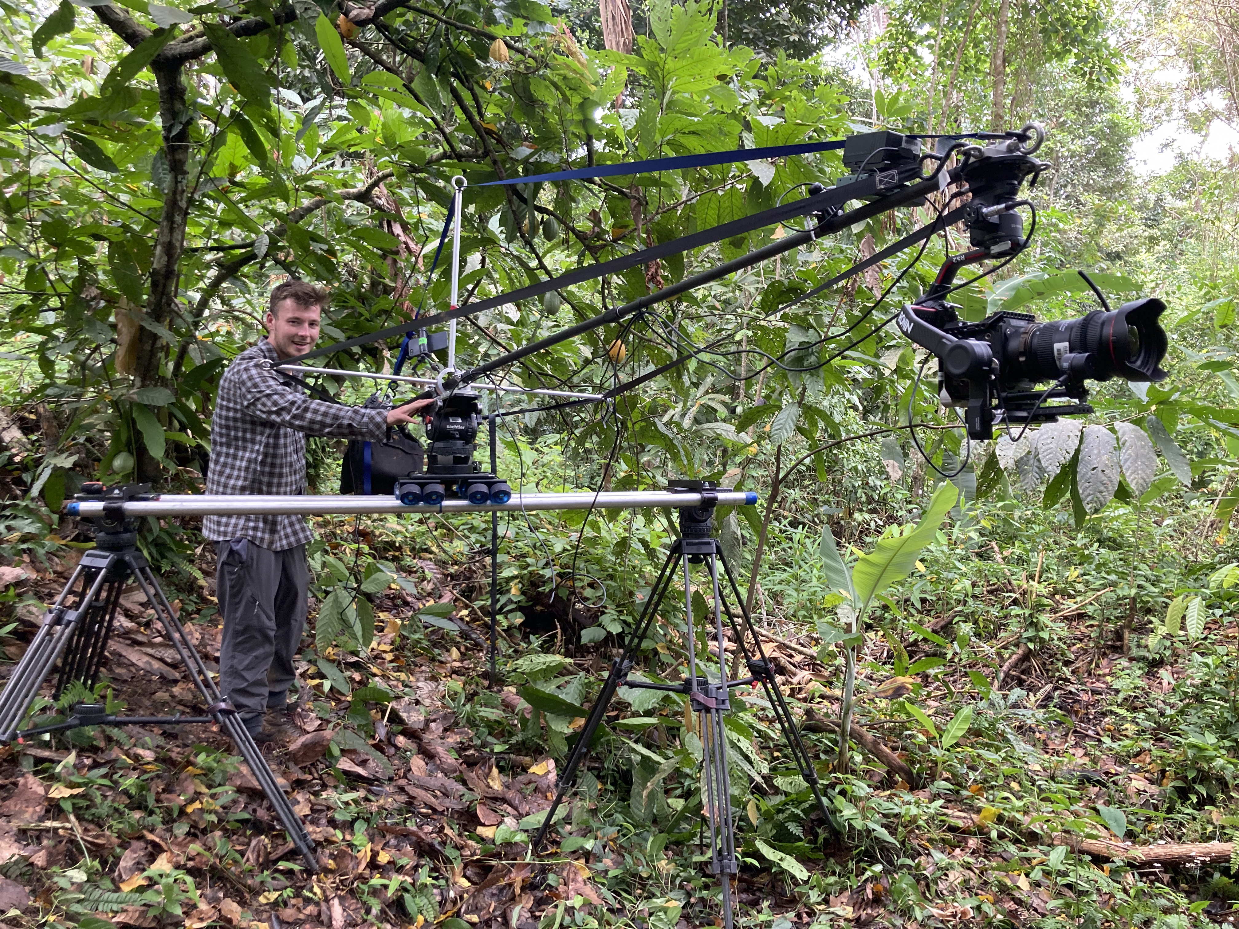 Matt Roseveare stands next to a camera crane to film pangolins in the Taiwan jungle.
