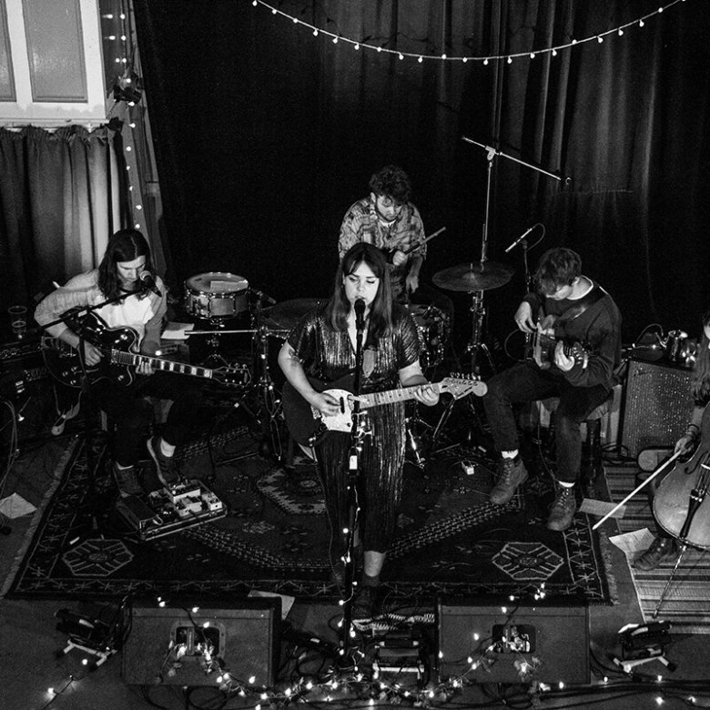 Music students playing instruments in a band with fairy lights