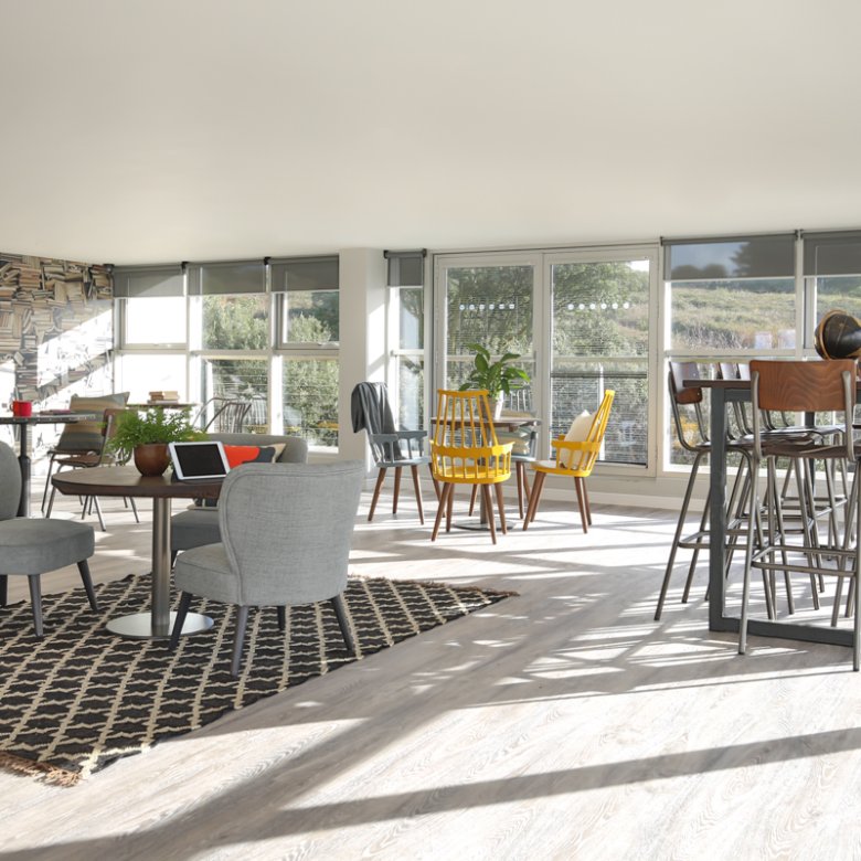 Living interior with dining table and arm chairs