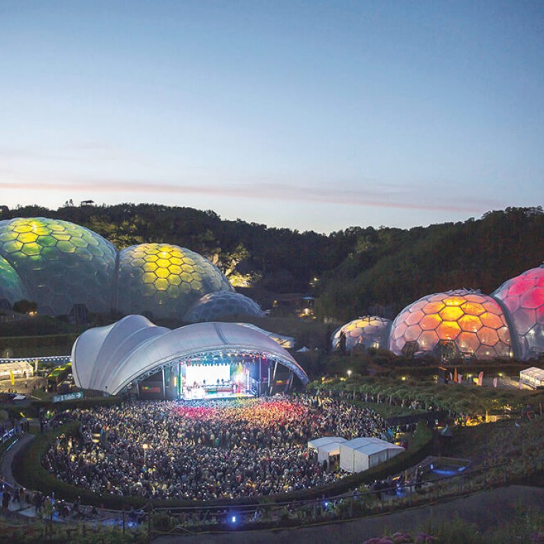 Aerial view of the Eden Project's domes lit up during an Eden Session's event.