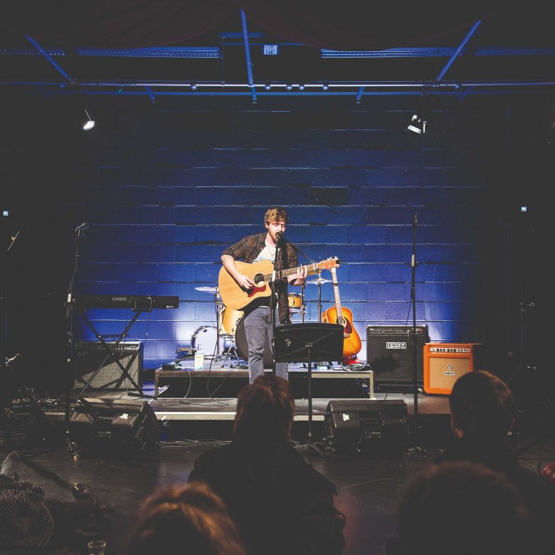 A guitarist performs on stage