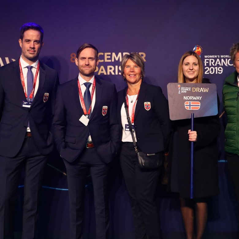 Five people standing in front of a purple wall with France 2019 FIFA