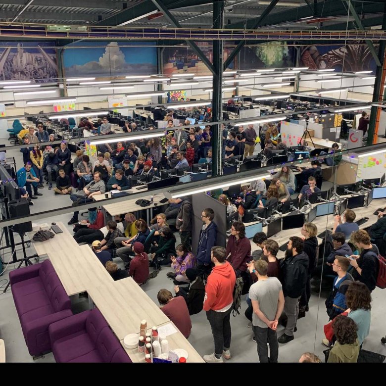 A crowd of students in the Games Academy with computers