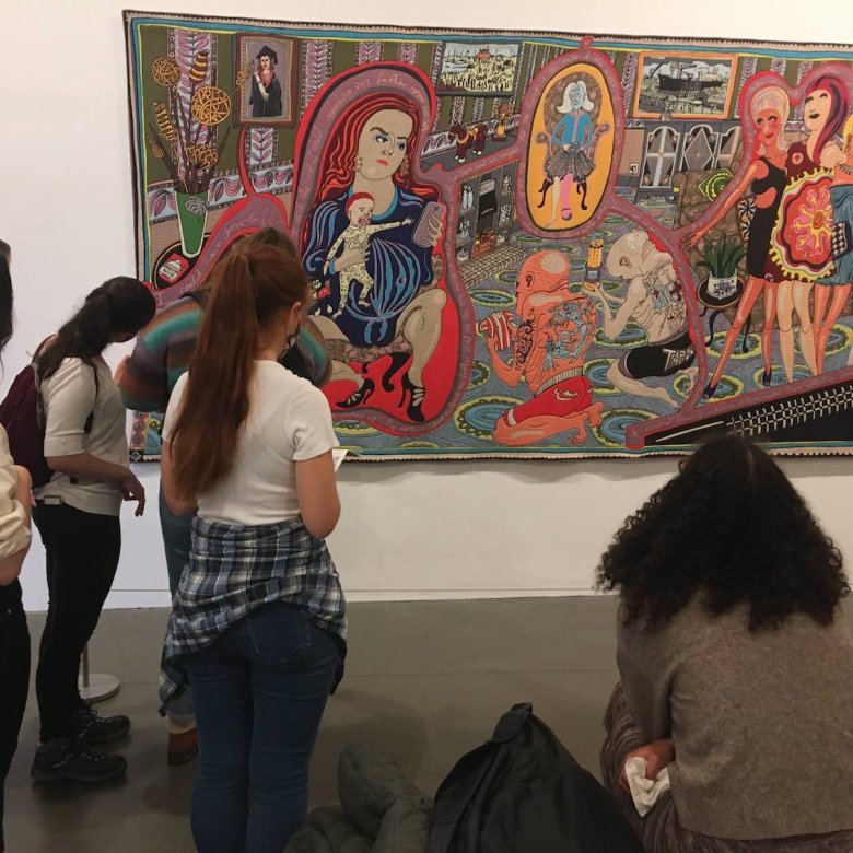 Falmouth University Illustration students looking at a large tapestry by artist, Grayson Perry