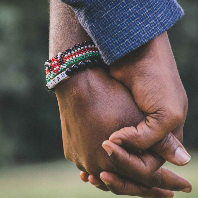 A close up image of hands being held