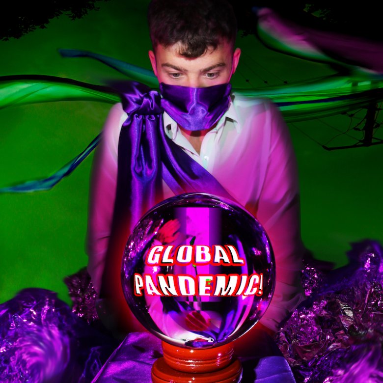 Boy wearing a purple cloak with a crystal ball