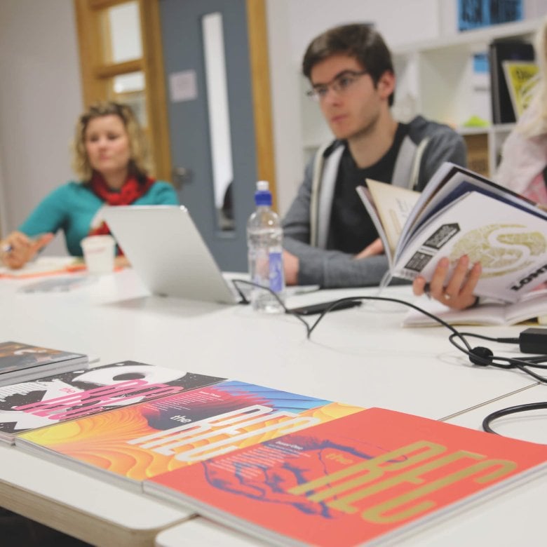 Falmouth University MA Graphic Design students at a table