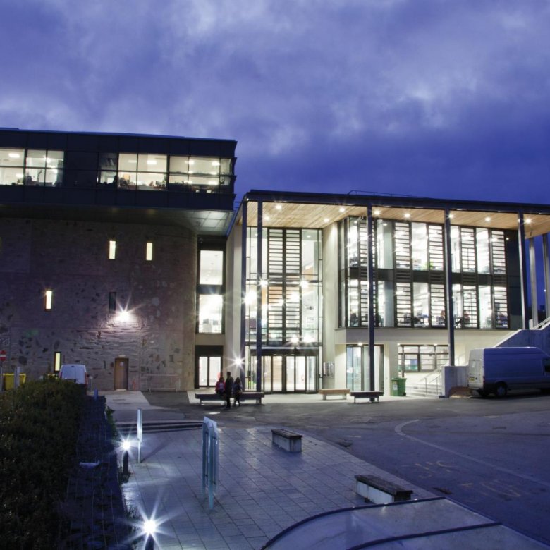 Penryn Campus glass building lit up at night