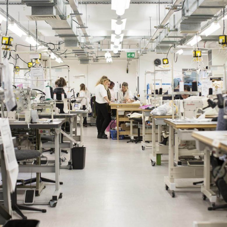 A view of the fashion department facilities at Falmouth University with tables with sewing machines.