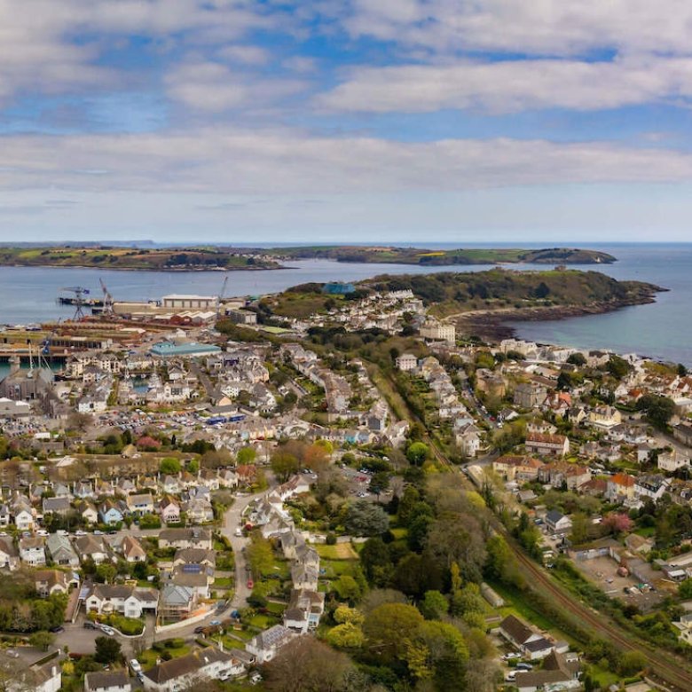 View from above of Falmouth, houses, coastline, sea and clouds.