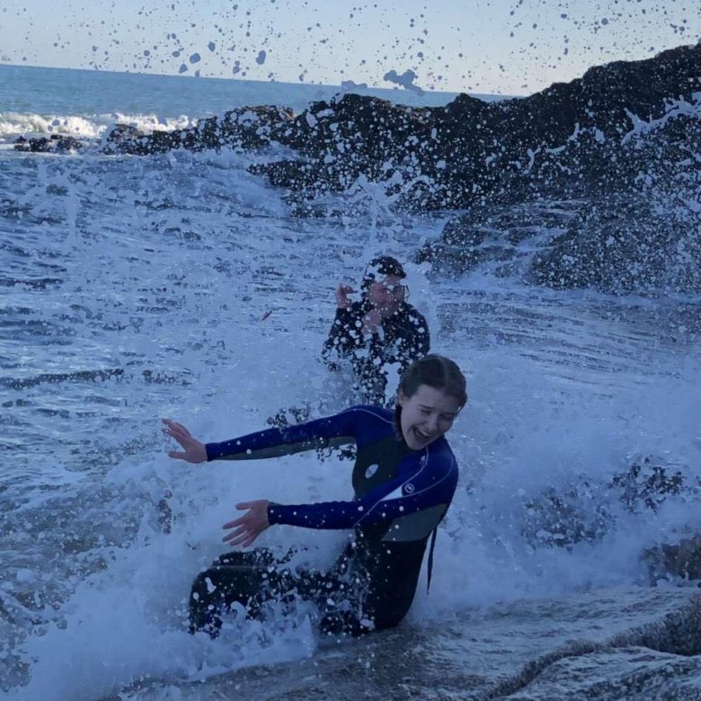 Two friends splash around in white water