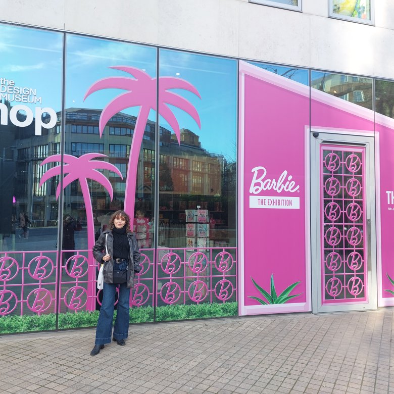 A woman stood outside a pink building
