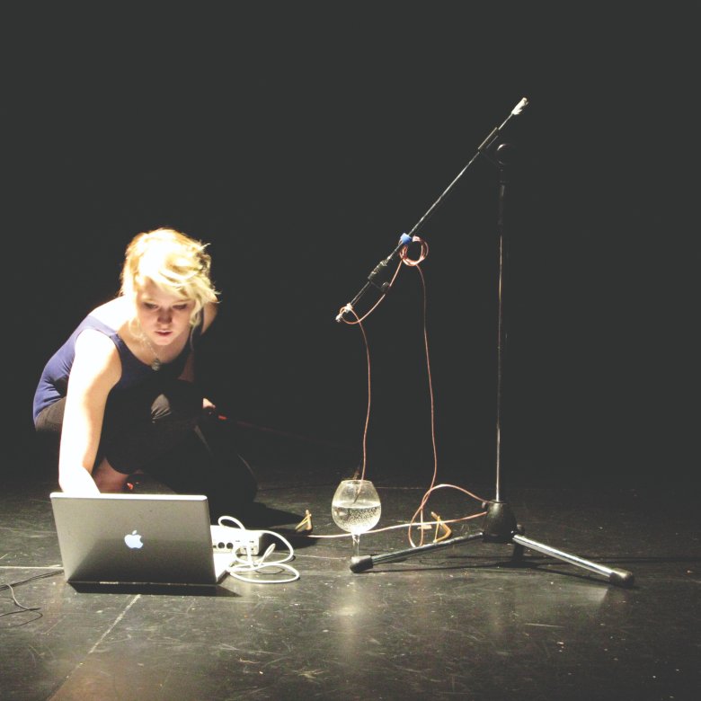Student on sound stage recording sound from a glass at Falmouth University