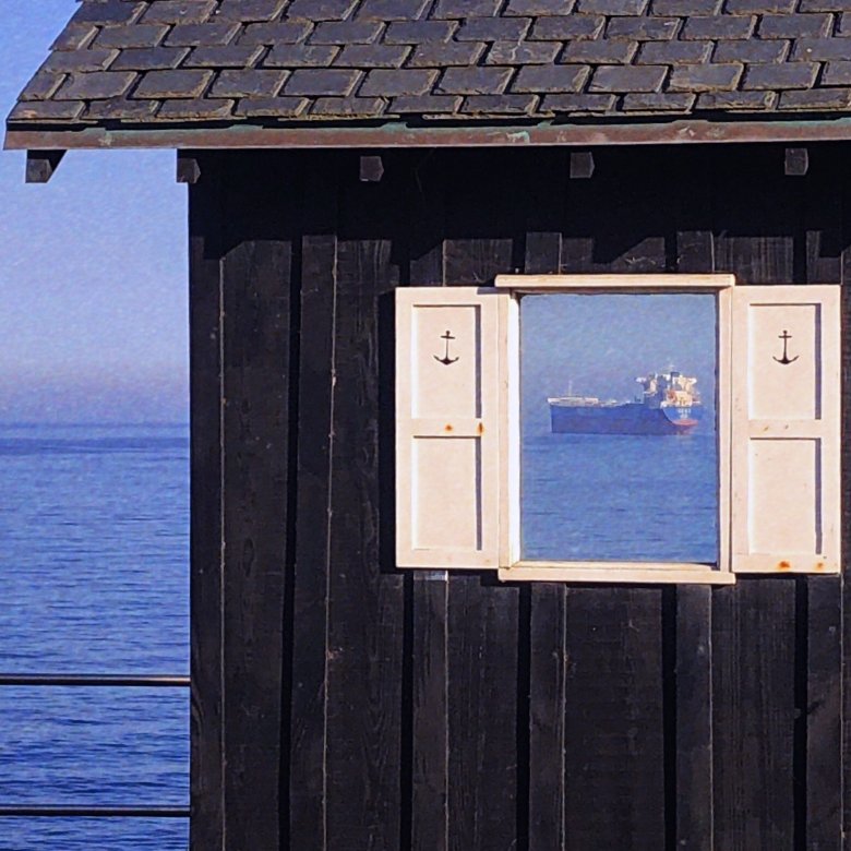 An open window reveals a large ferry