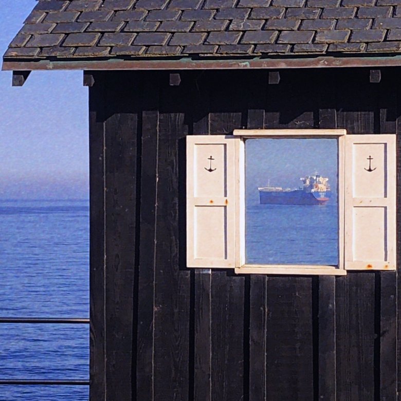 An open window reveals a large ferry 