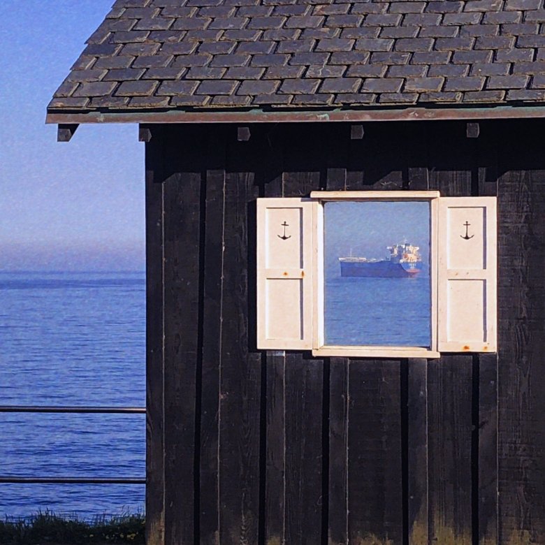 An open window reveals a large ferry 