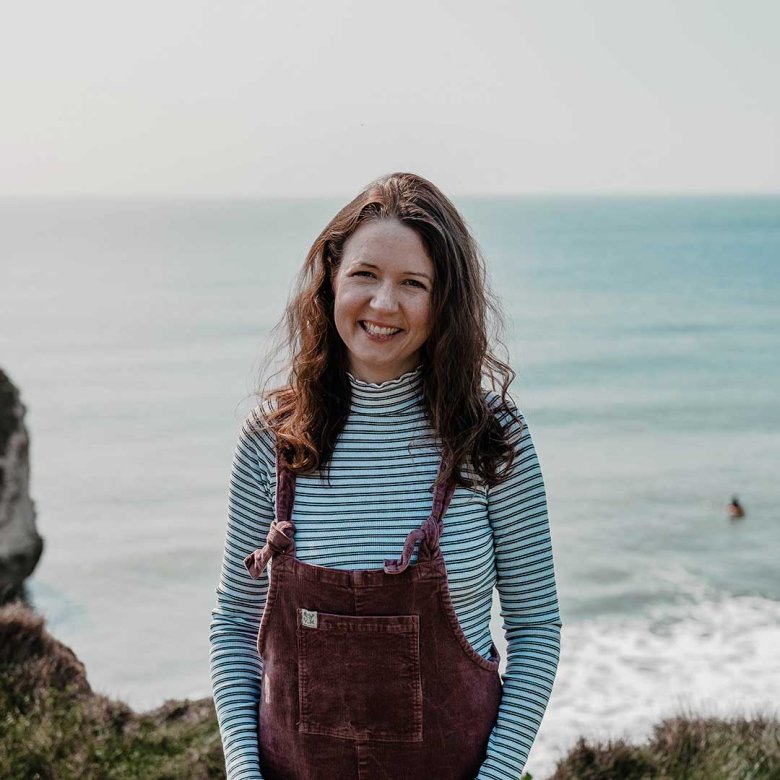Graduate Emma stood on a cliff on the Isle of Wight