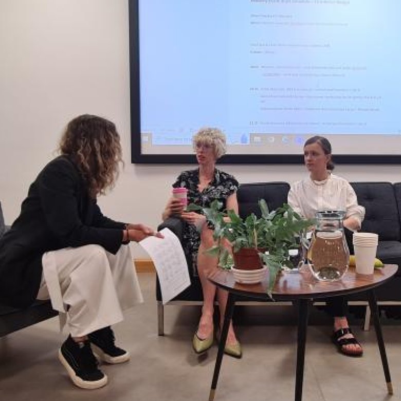 An Interior Design student sitting on a sofa with a lecturer and industry partner