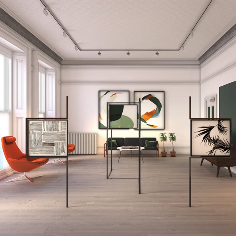 Interior design of large room with orange and green chairs and framed patterns