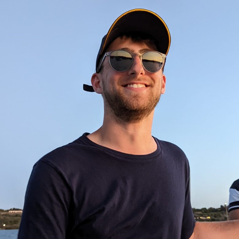 Man (Falmouth University graduate James Pearce) wearing black tshirt, sunglasses and cap