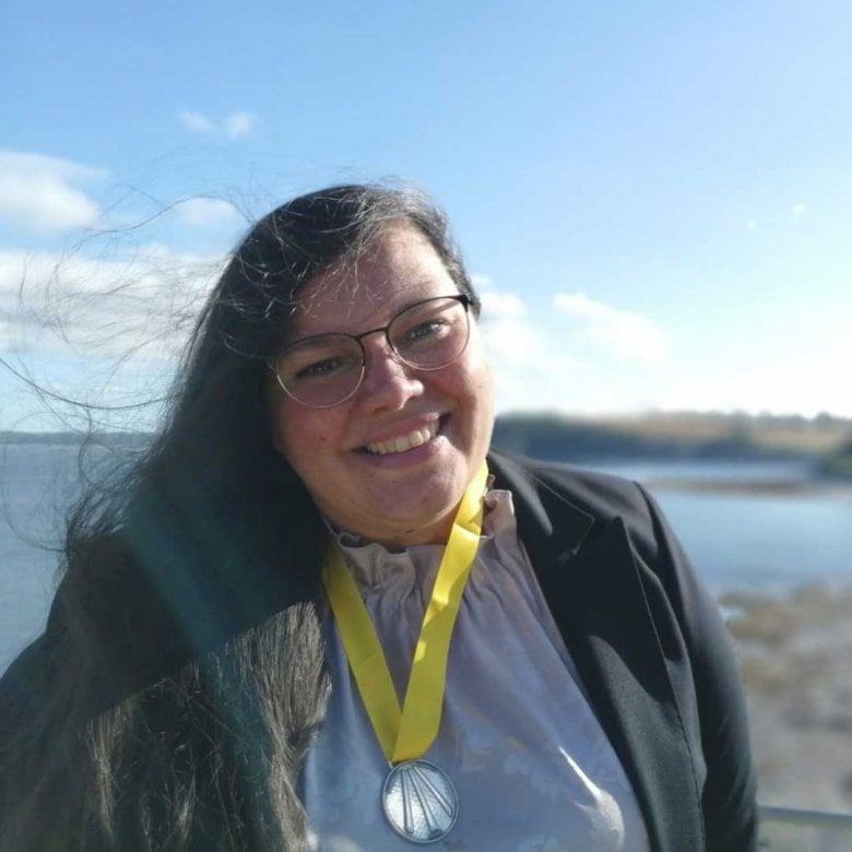 Dr Sherezade García Rangel standing in front of a lake 