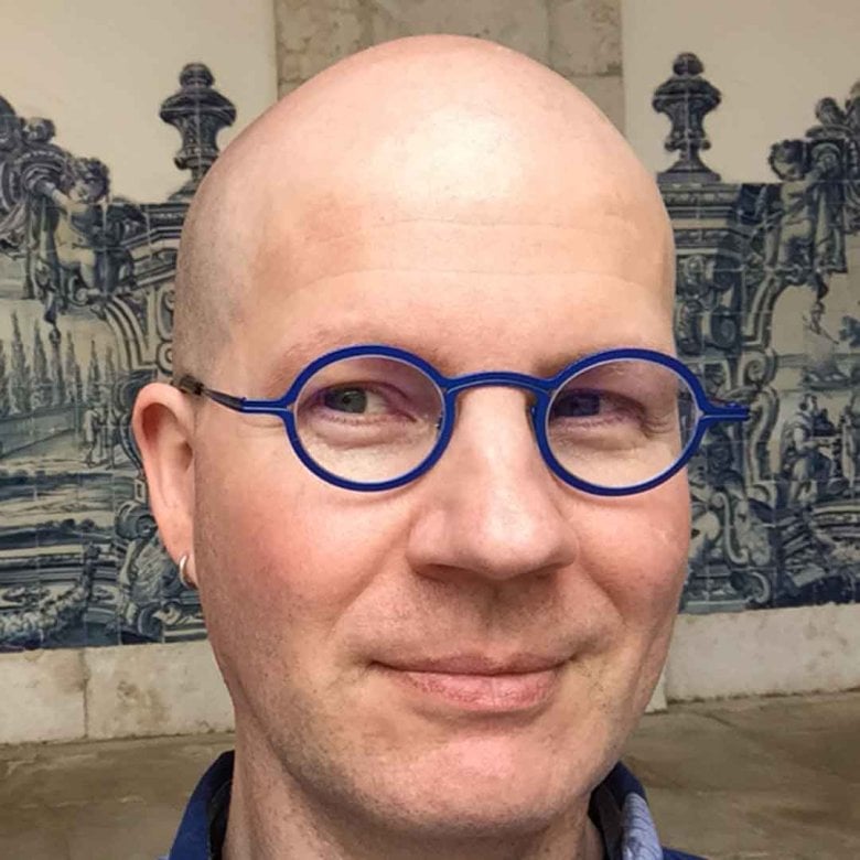 Dr Marshall Moore wearing blue-framed glasses
