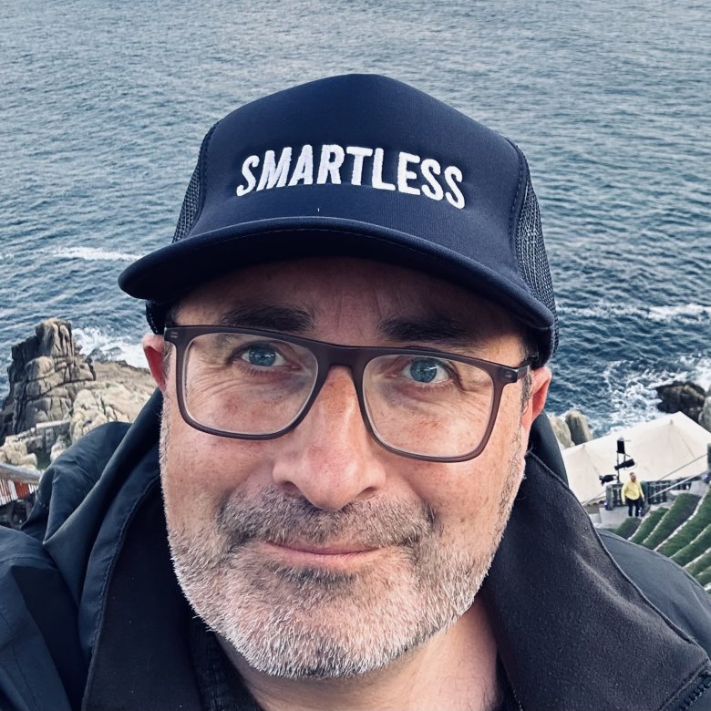 Headshot of comedy writing course leader wearing a cap