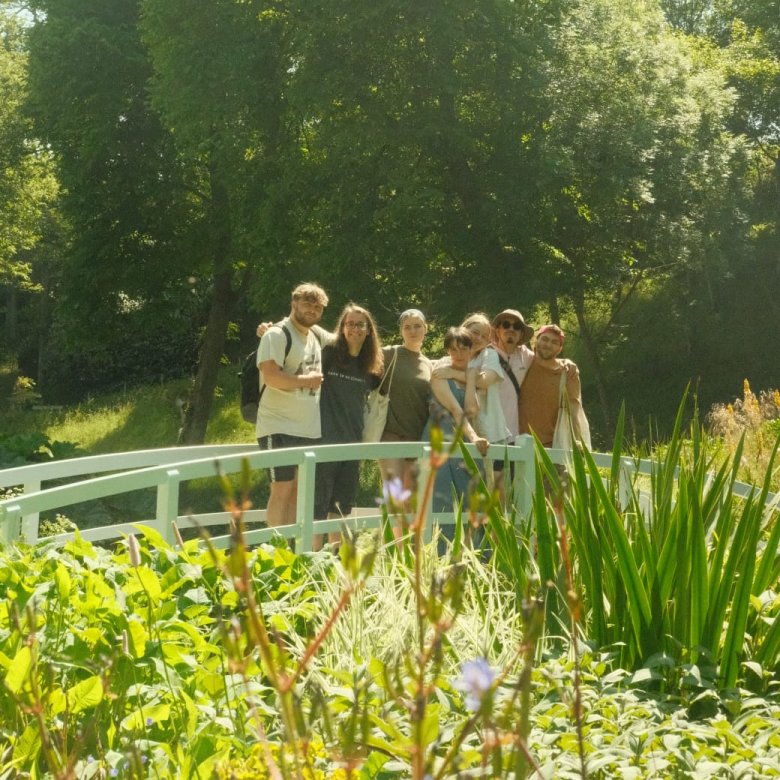 Falmouth students posing on a bridge in a garden