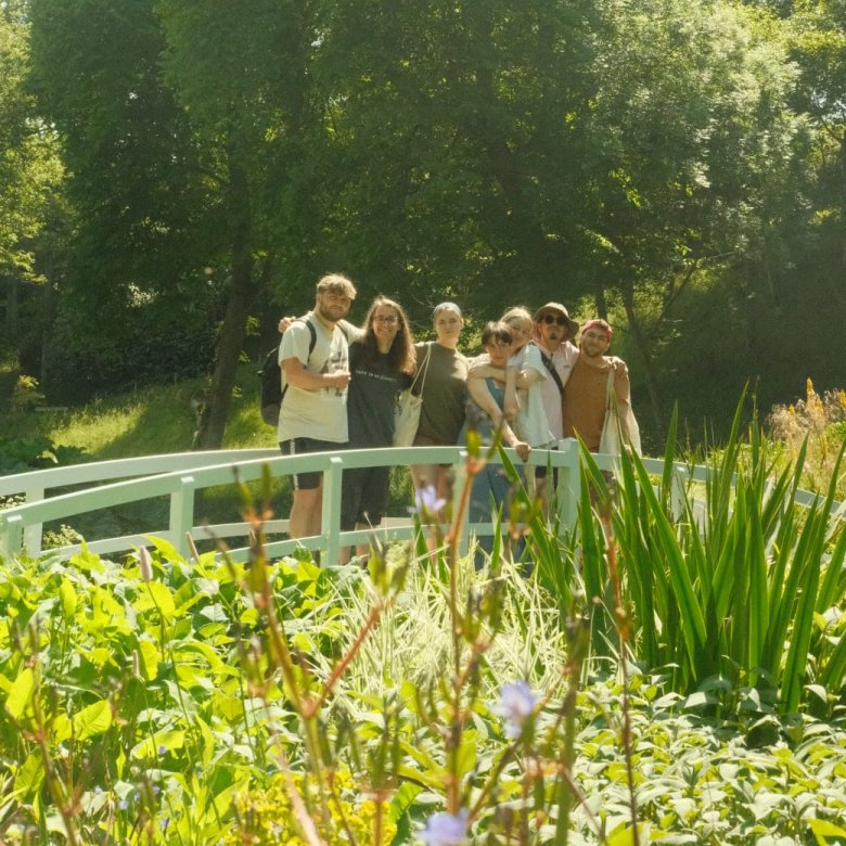 Falmouth students posing on a bridge in a garden