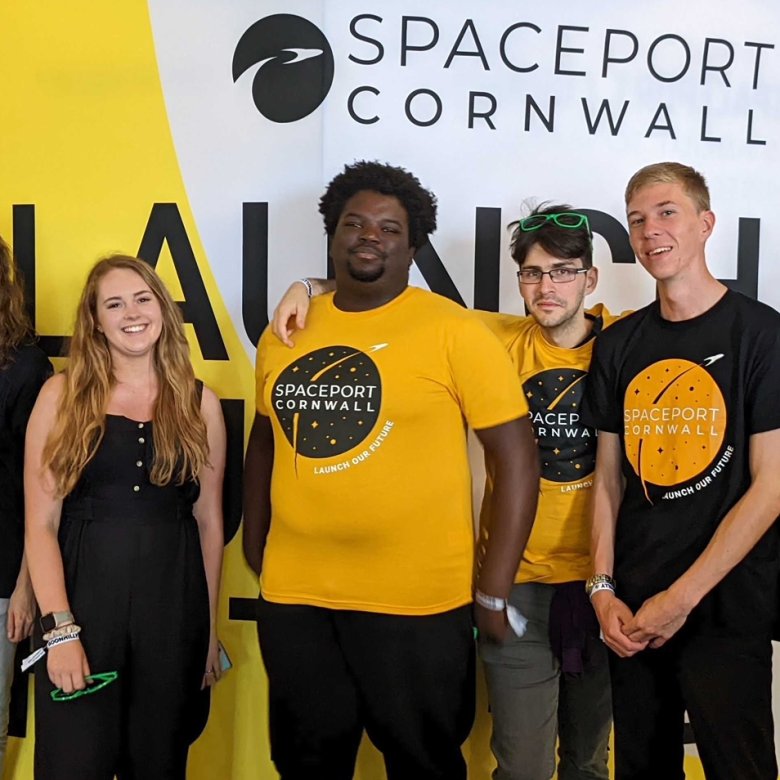 A group of students stand shoulder to shoulder wearing 'Spaceport Cornwall' tshirts