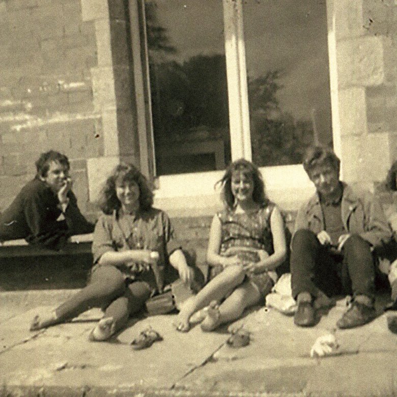 5 people, who are part of the Diploma in Art and Design Course, sit on the ground in front of Falmouth University in 1963.
