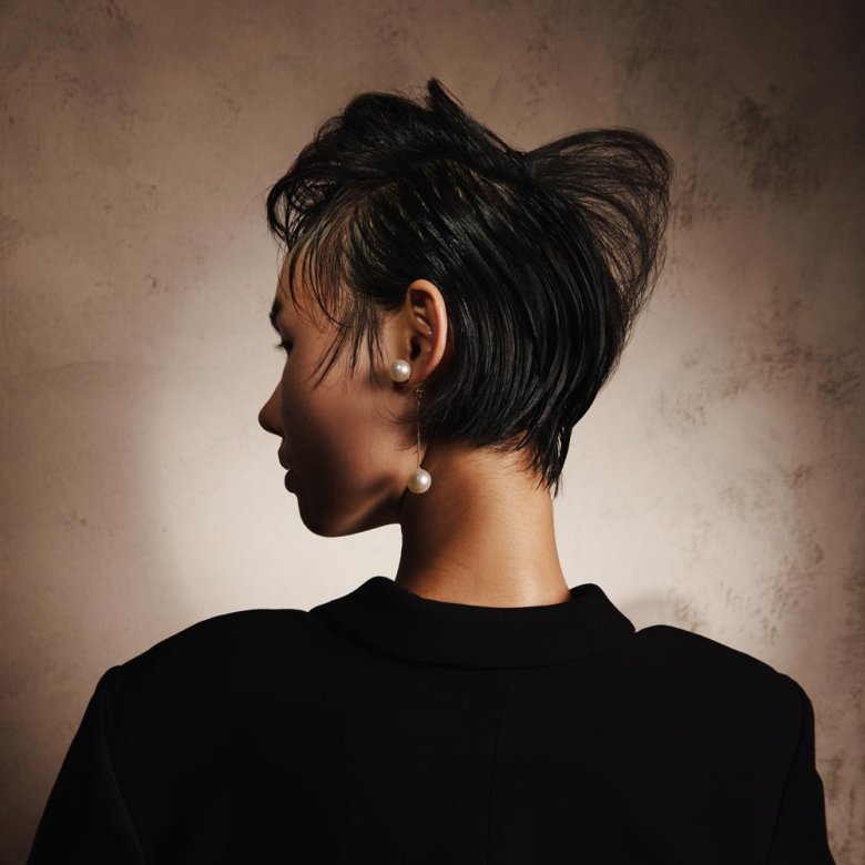 Photograph of the back of the head of a woman with cropped black hair