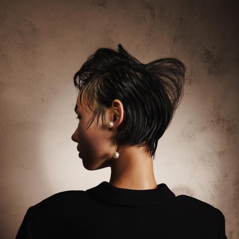 Photograph of the back of the head of a woman with cropped black hair