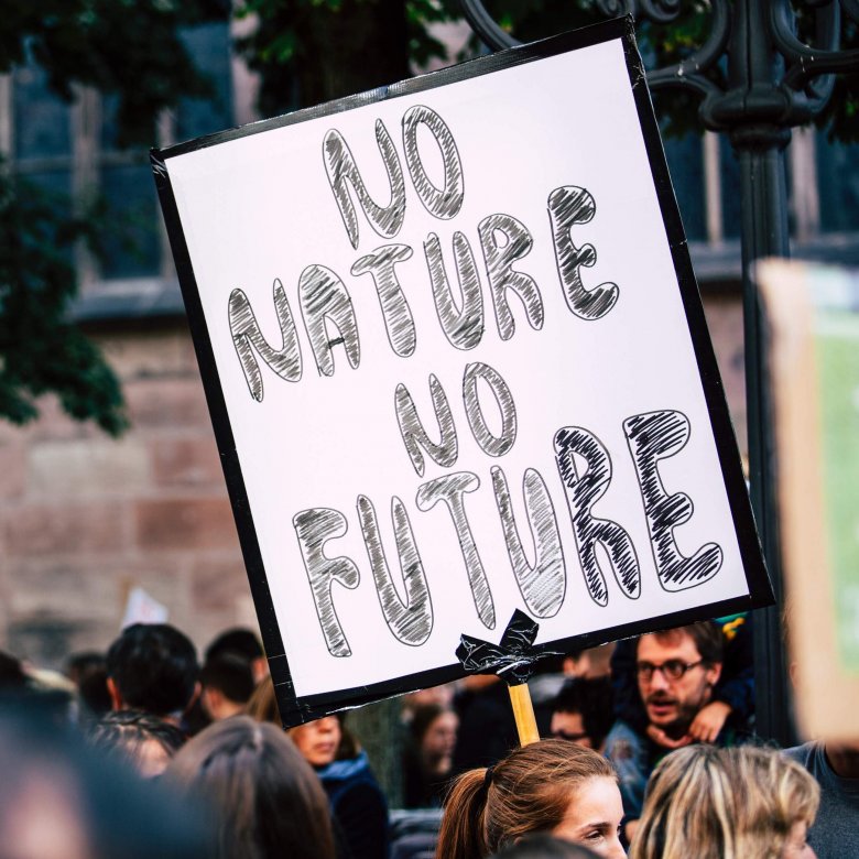 A placard reads 'No Nature, No Future' at a climate protest