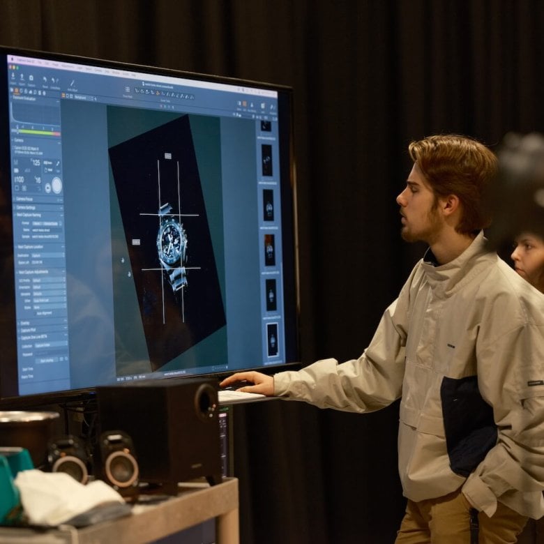 A Falmouth University Commercial Photography student editing a photograph of a watch on a large screen