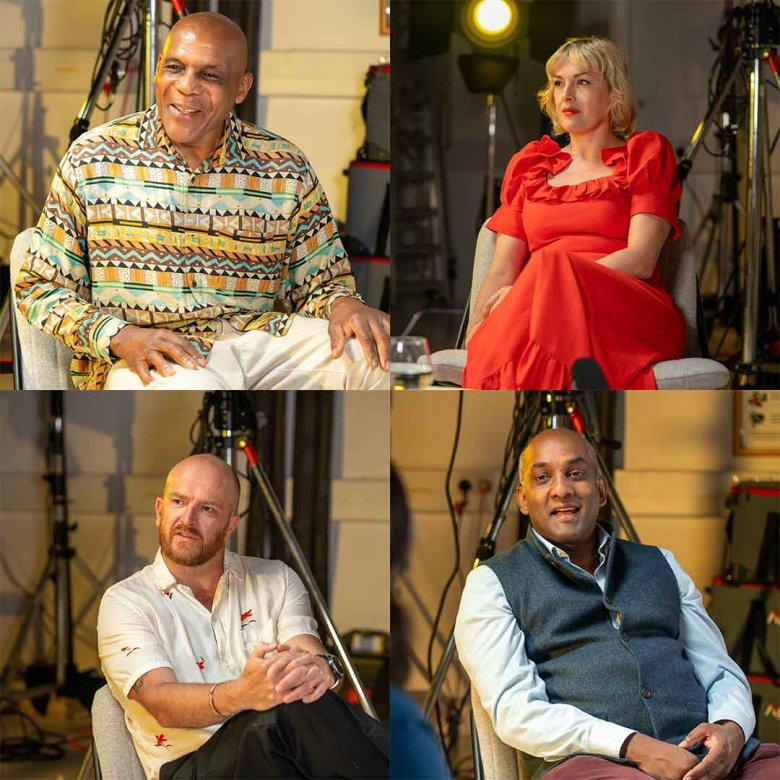 Four people being interviewed in a studio